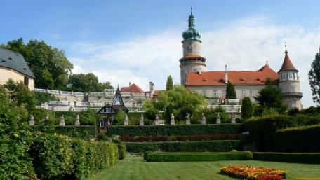 Charming Castle Surrounded by Lush Gardens and Clear Skies wallpaper
