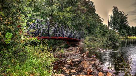 Serene Bridge Over Tranquil Waters In Nature's Embrace wallpaper