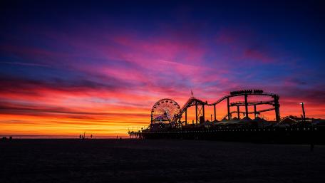Vibrant Sunset Over Amusement Pier Scene wallpaper