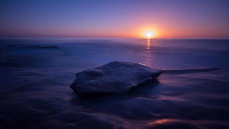 Serene Purple Sunset Over Calm Sea wallpaper