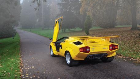 Stylish Yellow Sports Car in Autumn Landscape wallpaper