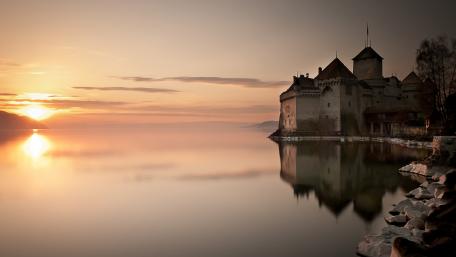 Serene Sunset Over Historic Castle Waterscape wallpaper