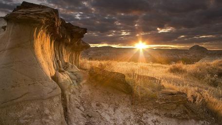Golden Sunset Over Desert Landscape wallpaper