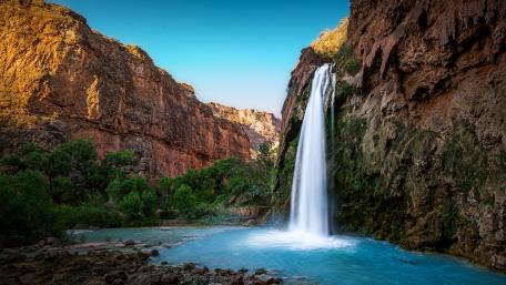 Majestic Waterfall Over Crystal Blue Pool wallpaper