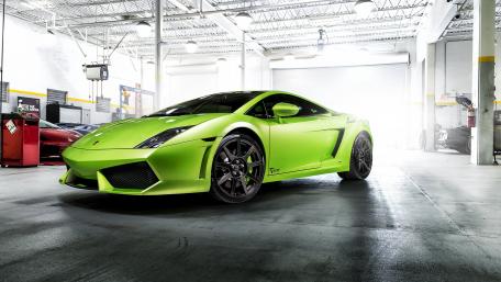Vibrant Green Lamborghini Gallardo in Workshop Setting wallpaper