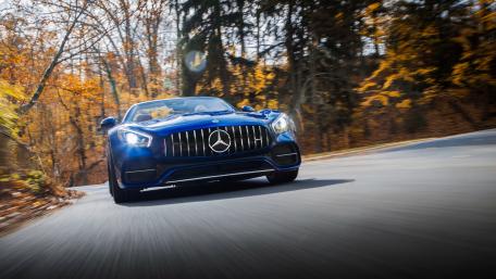 Sleek Blue Mercedes on Scenic Autumn Road wallpaper