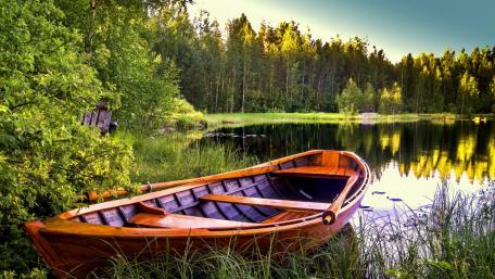 Tranquil Boat Scene Amidst Nature's Embrace wallpaper