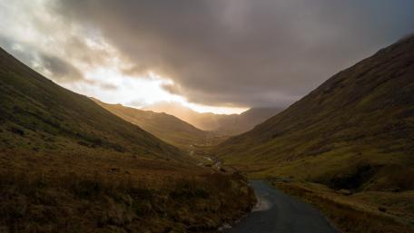 Serene Valley Under Cloudy Skies wallpaper