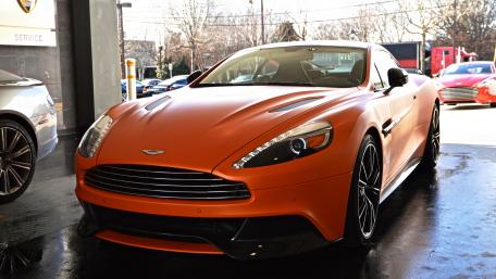 Sleek Orange Aston Martin Design Wallpaper wallpaper