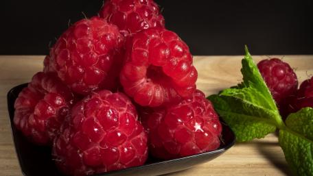 Fresh Raspberries with Mint Leaves for a Refreshing Touch wallpaper