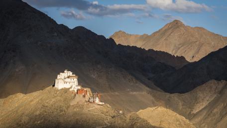 Majestic Monastery Amidst Mountain Peaks wallpaper