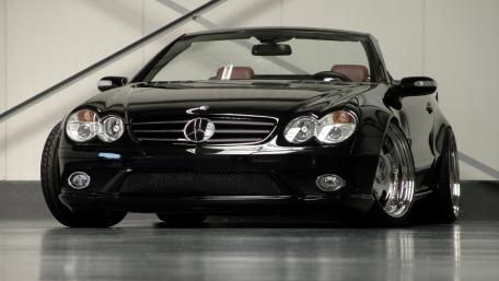 Sleek Black Convertible Luxury Car Wallpaper wallpaper