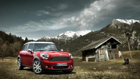 Stylish Red Car in Majestic Mountains wallpaper