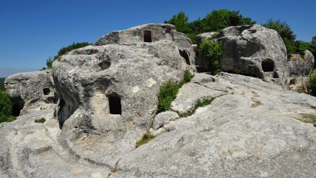 Ancient Cliffside Dwellings Amidst Nature's Grandeur wallpaper