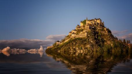 Majestic Castle Overlooking Serene Waters wallpaper