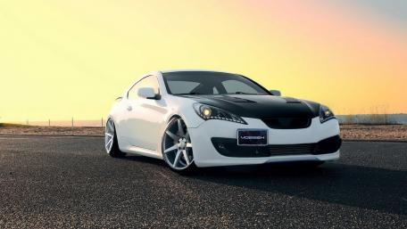 Sleek Performance Car Against a Sunset Horizon wallpaper