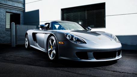 Sleek Silver Porsche in Urban Setting wallpaper