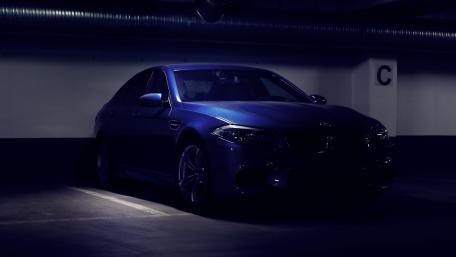 Sleek BMW in Ambient Garage Lighting wallpaper