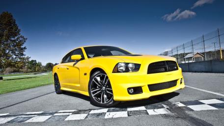 Vibrant Yellow Muscle Car on Track wallpaper