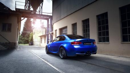 Sleek Blue BMW in Industrial Setting wallpaper