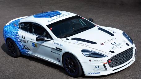 Sleek White Aston Martin with Vibrant Graphics on Display wallpaper