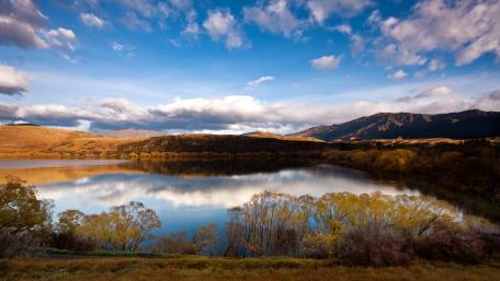 Tranquil Lake Under a Dramatic Sky wallpaper