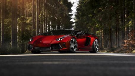 Sleek Red Lamborghini on a Forest Road wallpaper