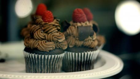 Delicious Chocolate Cupcakes Topped with Raspberries wallpaper