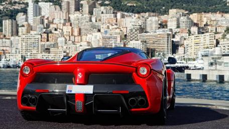 Sleek Red Ferrari Overlooking Monaco's Skyline wallpaper