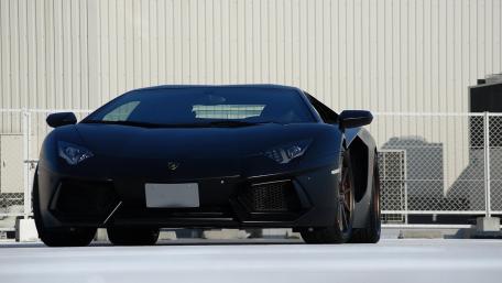 Sleek Black Supercar Ready to Roar wallpaper