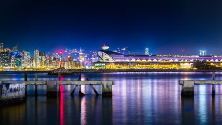 Vibrant Night Cityscape Over Water wallpaper