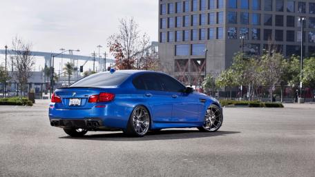 Sleek Blue BMW M5 in Urban Setting wallpaper