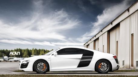 Sleek White Sports Car Under Dramatic Sky wallpaper