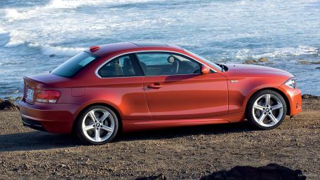 Sleek Performance Car by the Ocean Shore wallpaper