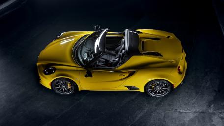 Sleek Yellow Sports Car Under Dramatic Lighting wallpaper