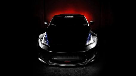 Sleek Black Sports Car with Eye-Catching Lighting Effects wallpaper