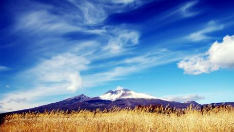 Majestic Mountain Under Blue Skies wallpaper