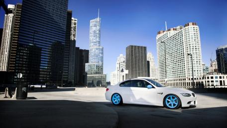 Sleek White Car Against Urban Skyline wallpaper