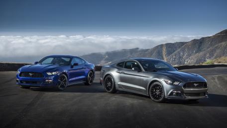 Sleek Mustangs Against a Cloudy Skyline wallpaper