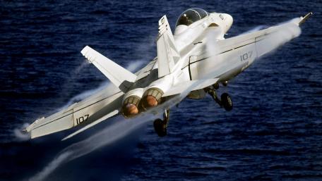 Fighter Jet Ascending Over Ocean Waves wallpaper