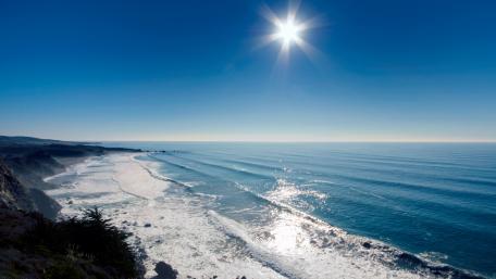 Serene Coastline under a Brilliant Blue Sky wallpaper