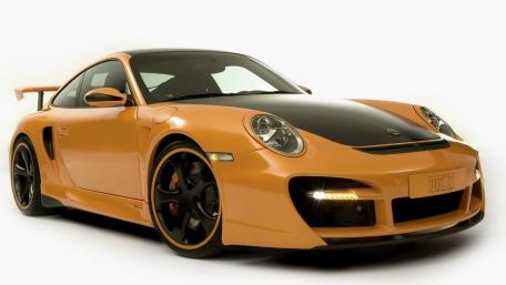 Sleek and Stylish Orange Sports Car Wallpaper wallpaper