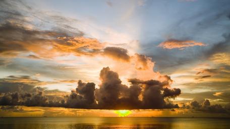 Golden Horizon Under Dramatic Clouds wallpaper