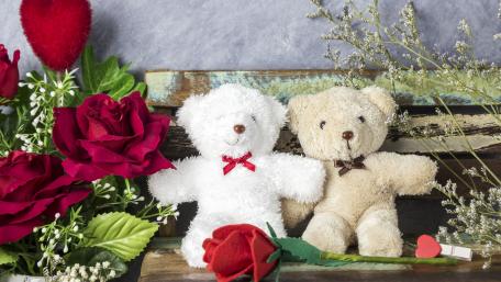Teddy Bears Surrounded by Roses in a Romantic Setting wallpaper