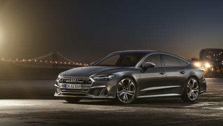 Sleek and Powerful Audi A7 in City Light wallpaper