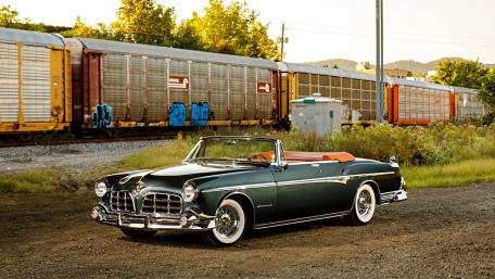 Classic Convertible Surrounded by Train Tracks and Nature wallpaper