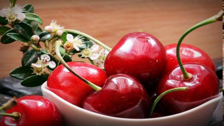 Fresh and Juicy Cherries in a Bowl wallpaper