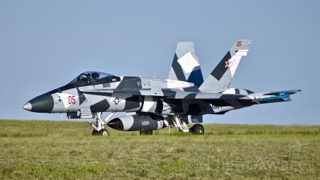 Futuristic Jet Displaying Bold Camouflage Patterns in Combat Readiness wallpaper
