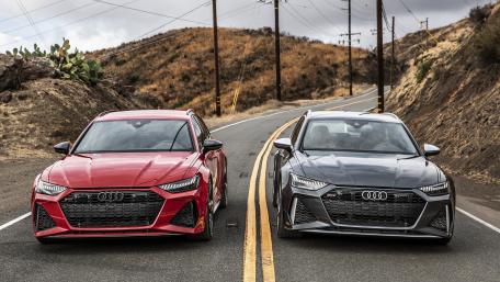 Sleek Audi Duo on Scenic Roadway wallpaper
