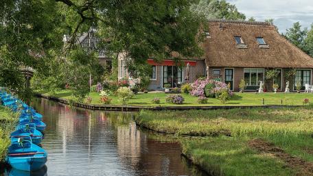 Tranquil Waterside Retreat Amidst Lush Greenery wallpaper